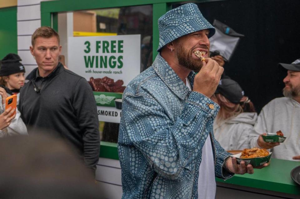 Travis Kelce chows down on chicken wings from the Wing Stop booth during Kelce Jam at the Azura Amphitheater on Friday, April 28, 2023, in Bonner Springs.