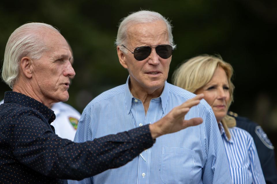 The mayor of Live Oak, Frank Davis, talks to President Joe Biden on Saturday. The president and the first lady visited Live Oak to meet community members and assess damage from Hurricane Idalia.