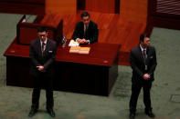 Hong Kong Chief Executive Leung Chun-ying sits behind security guards before his policy address at the Legislative Council in Hong Kong, China January 18, 2017. REUTERS/Bobby Yip