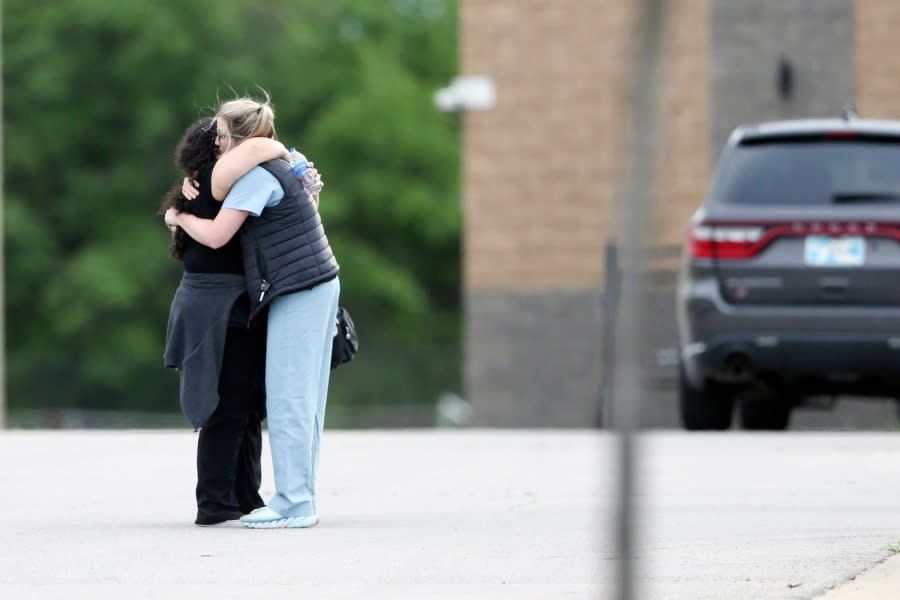 Two people hug as they are reunited at Memorial High School after being evacuated from the scene of a shooting at the Natalie Medical Building Wednesday, June 1, 2022. in Tulsa, Okla. Multiple people were shot at a Tulsa medical building on a hospital campus Wednesday. (Ian Maule/Tulsa World via AP)