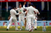 Cricket - India v New Zealand - First Test cricket match - Green Park Stadium, Kanpur, India - 22/09/2016. New Zealand's Mitchell Santner celebrates with teammates after taking the wicket of India's Lokesh Rahul. REUTERS/Danish Siddiqui