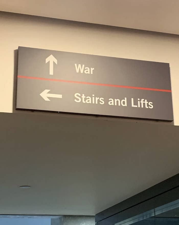 Directional sign indicating "War" with an arrow pointing up, and "Stairs and Lifts" with an arrow to the left