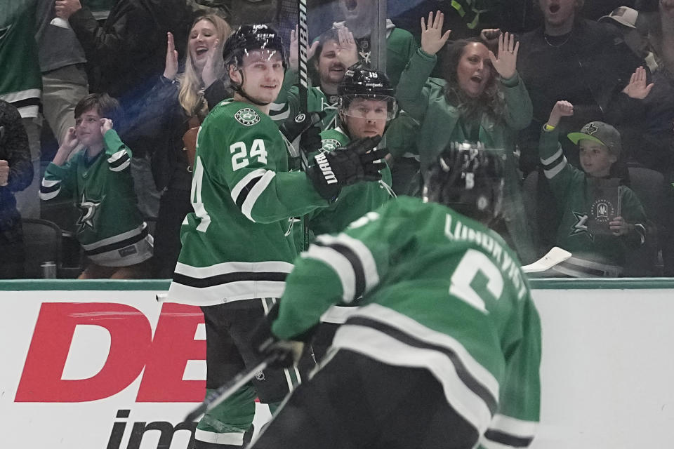 Dallas Stars center Roope Hintz (24) celebrates with teammates after scoring during the second period of an NHL hockey game against the Chicago Blackhawks in Dallas, Friday, Dec. 29, 2023. (AP Photo/LM Otero)