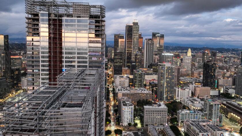 Los Angeles, CA, Thursday, February 1, 2024 - Taggers have graffitied what appears to be more than 25 stories of a downtown Los Angeles skyscraper that's been sitting dormant for several years. Construction on Oceanwide Plaza, a $1 billion mixed-use retail and luxury apartments project with three towering unfinished structures, stalled in January 2019 after the Beijing-based developer lacked the funds to complete it. (Robert Gauthier/Los Angeles Times)