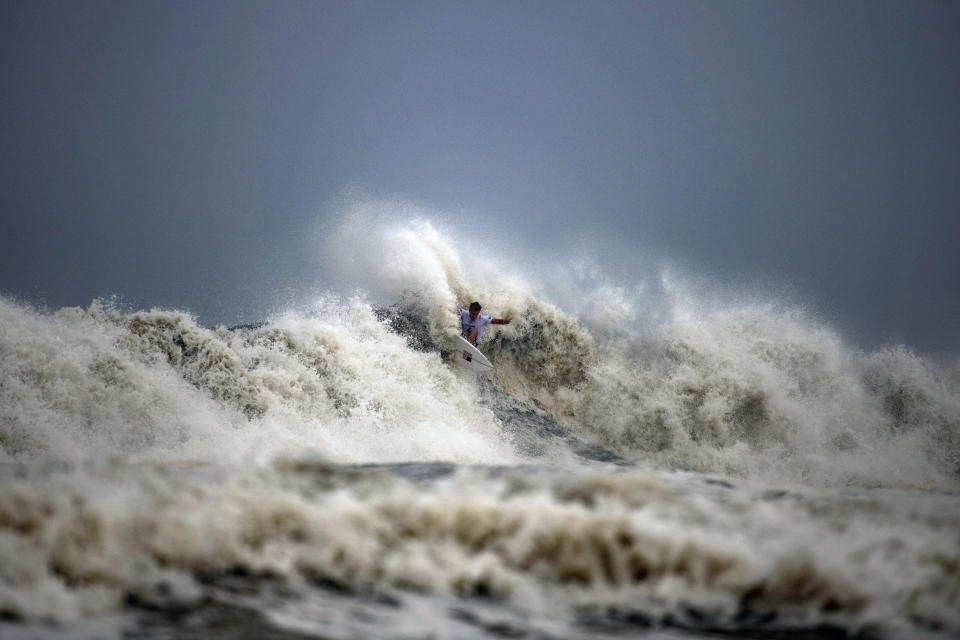 Kolohe Andino, of the United States, rides a wave during the quarterfinals of the men's surfing competition at the 2020 Summer Olympics, Tuesday, July 27, 2021, at Tsurigasaki beach in Ichinomiya, Japan. (Olivier Morin/Pool Photo via AP)