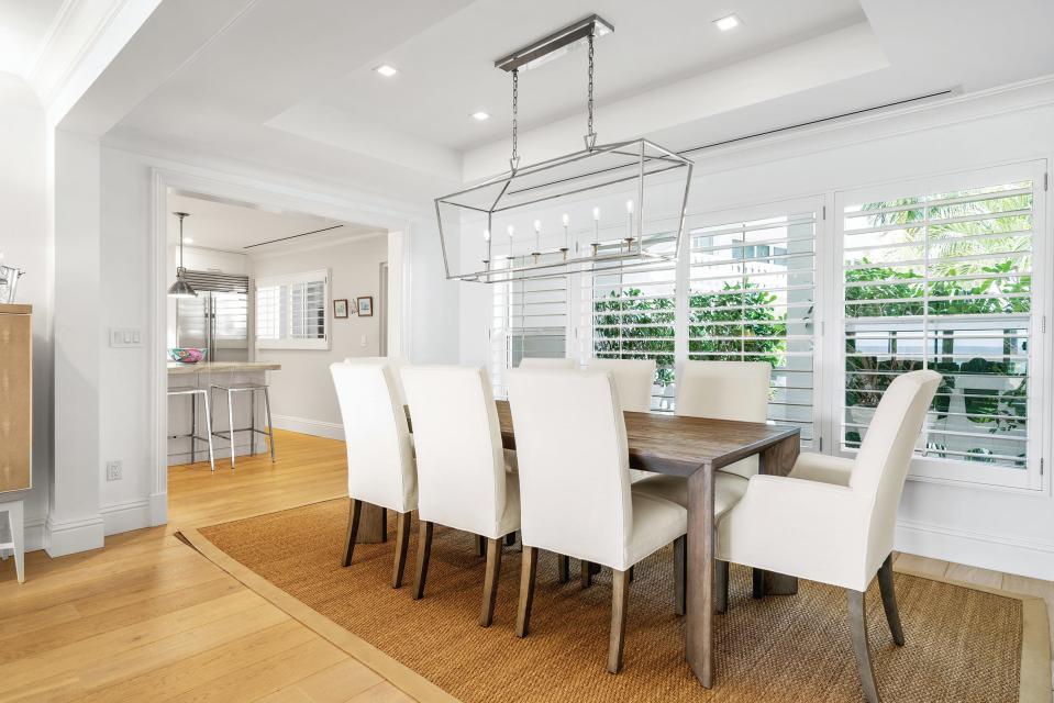 The dining room at Unit 2D of the 300 Building, 300 S. Ocean Blvd. in Palm Beach opens up to the kitchen.