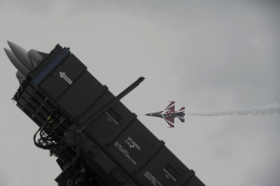 An F-16 fighter jet flies past the Rafael Advanced Defense Systems' SPYDER surface-to-air missile system, during a performance by the Singapore Air Force aerobatics team Black Knights on the fourth day of the Singapore Airshow in Singapore Friday, Feb. 14, 2014. Rafael Advanced Defense Systems developing a laser-based missile shield that evokes "Star Wars" style technology said its deployment over the country is closer to becoming a reality. The Israeli state-owned arms company said development of the system was advanced enough for the company to be comfortable with publicizing it at the airshow, which is Asia's largest aerospace and defense exhibition. (AP Photo/Joseph Nair)