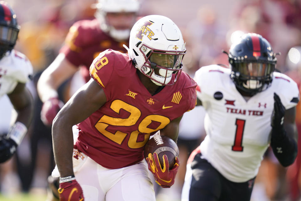 Iowa State running back Breece Hall (28) runs from Texas Tech linebacker Krishon Merriweather (1) during the first half of an NCAA college football game, Saturday, Oct. 10, 2020, in Ames, Iowa. (AP Photo/Charlie Neibergall)