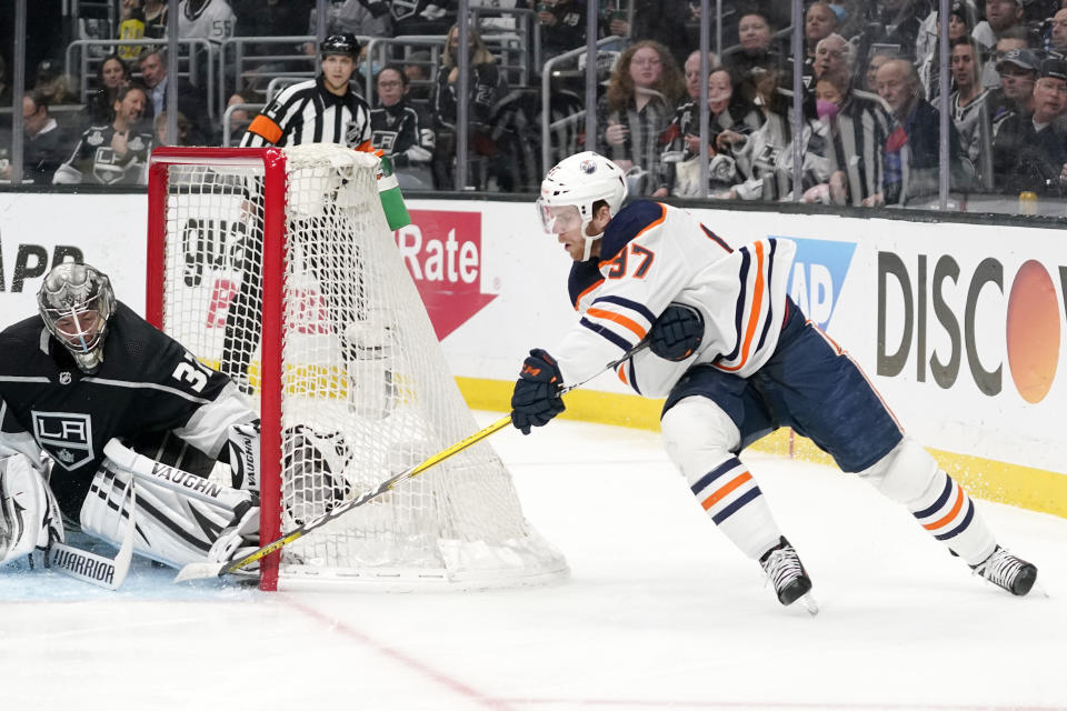 Edmonton Oilers center Connor McDavid, right, scores on Los Angeles Kings goaltender Jonathan Quick during the first period in Game 6 of an NHL hockey Stanley Cup first-round playoff series Thursday, May 12, 2022, in Los Angeles. (AP Photo/Mark J. Terrill)