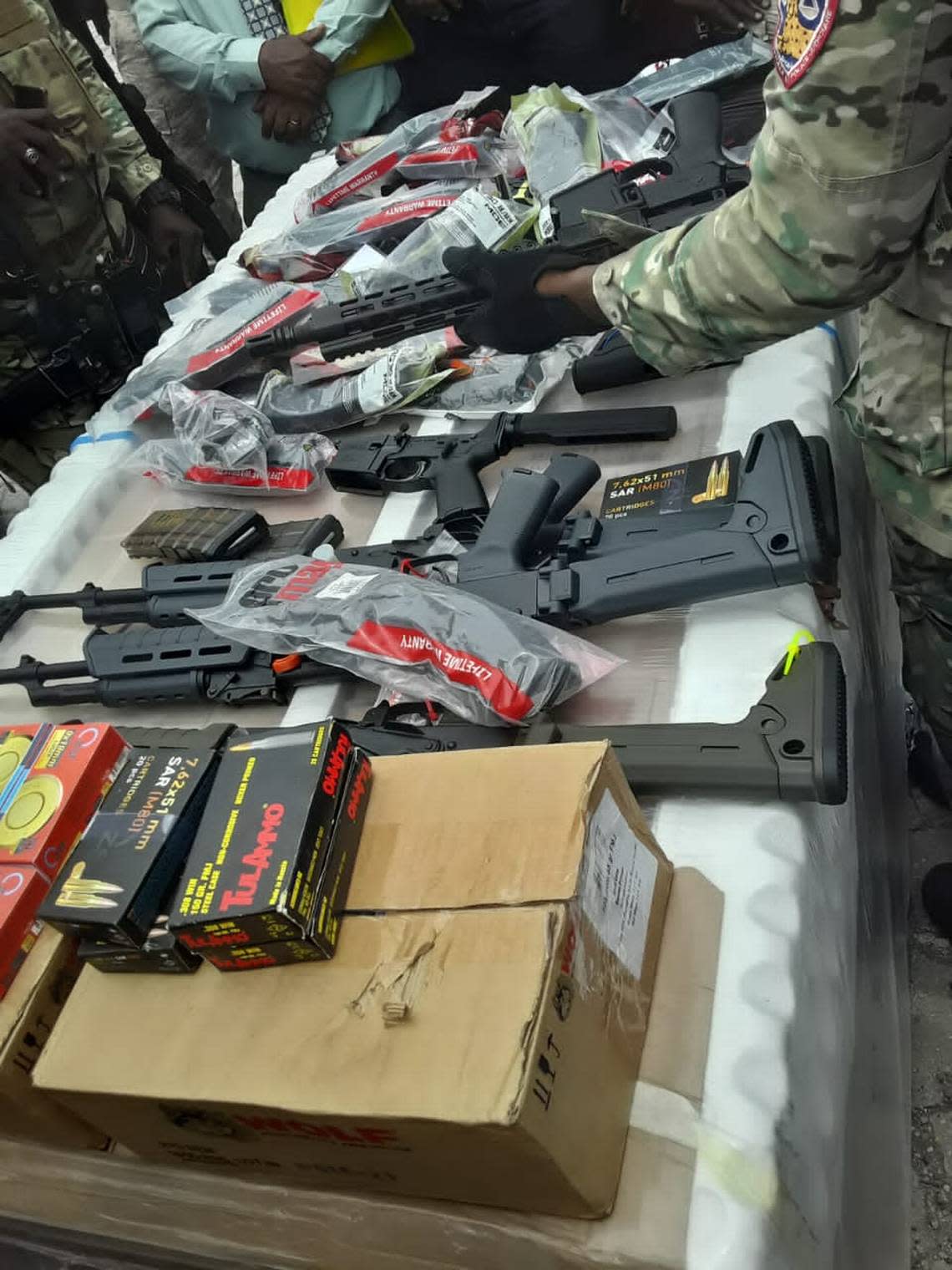 Automatic weapons and ammunition from an illegal shipment that Haitian police discovered Thursday, July 14, 2022.
