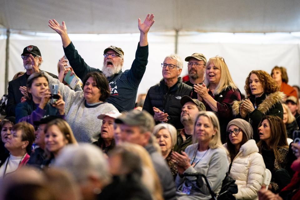 The crowd reacts to presenters during the ReAwaken America Tour at Global Vision Bible Church in Mt. Juliet, Tenn., Friday, Jan. 20, 2023.