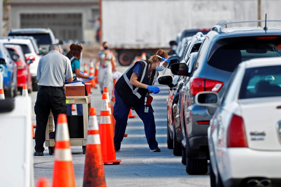 Florida Department of Health medical workers prepare to administer a COVID-19 vaccine to seniors in the parking lot of the Gulf View Square Mall in New Port Richey near Tampa, Florida, U.S. December 31, 2020.  REUTERS/Octavio Jones