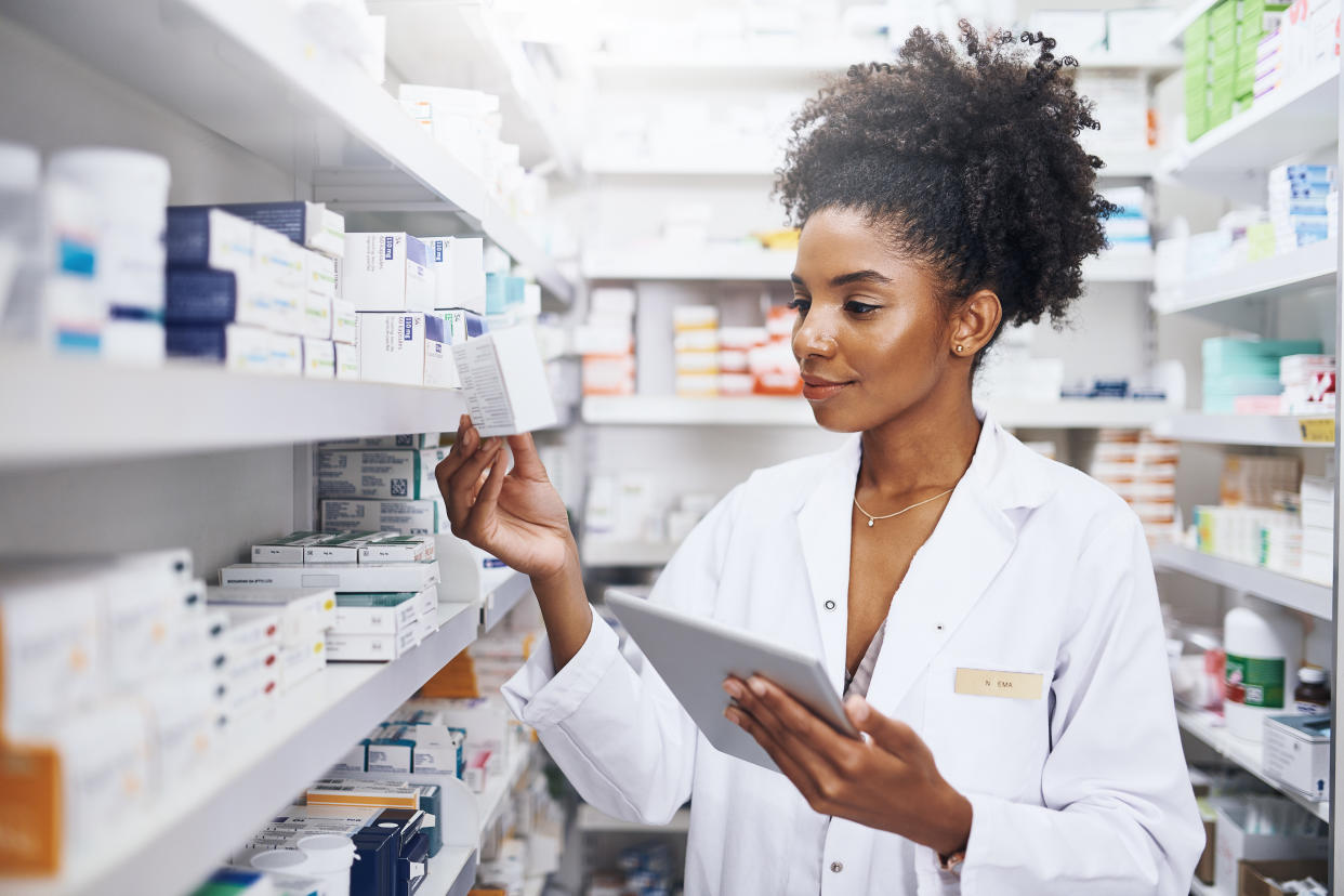 Cropped shot of a pharmacist using a digital tablet in a chemist