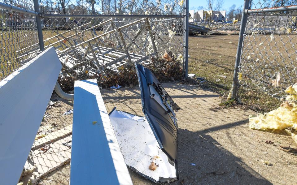 A destroyed big-screen television ended up in the enclosed dugout of the ballfields behind what remains of the Flatwood Community Center after a tornado hit the Flatwood community, north of Montgomery, on Wednesday, Nov. 30, 2022.