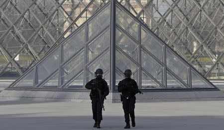 French police secure the site near the Louvre Pyramid in Paris, France, February 3, 2017 after a French soldier shot and wounded a man armed with a machete and carrying two bags on his back as he tried to enter the Paris Louvre museum. REUTERS/Christian Hartmann