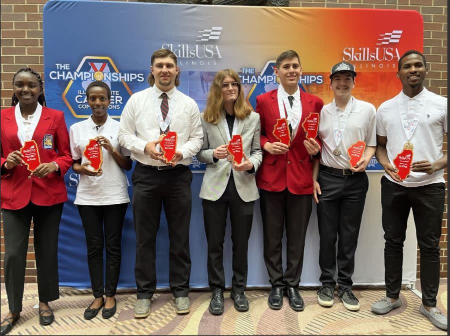 Sandburg students (l-r) Faith Kiprop, Ascar Jepchirchir, Deven Bushong, Sullivan Ross, Gavin Gerard, Ryan Leary and Brian Kipchemis hold their awards from the SkillsUSA Illinois Championships on April 26 in Peoria. Gerard (masonry, job interview), Kiprop (technical computer applications), Kipchemis (medical math) Jepchirchir (medical terminology) and Ross (welding sculpture) won their respective categories to advance to the national competition next month in Atlanta. (Courtesy Carl Sandburg College)