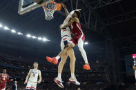 Alabama forward Nick Pringle is fouled by UConn center Donovan Clingan, left, during the first half of the NCAA college basketball game at the Final Four, Saturday, April 6, 2024, in Glendale, Ariz. (AP Photo/Brynn Anderson )