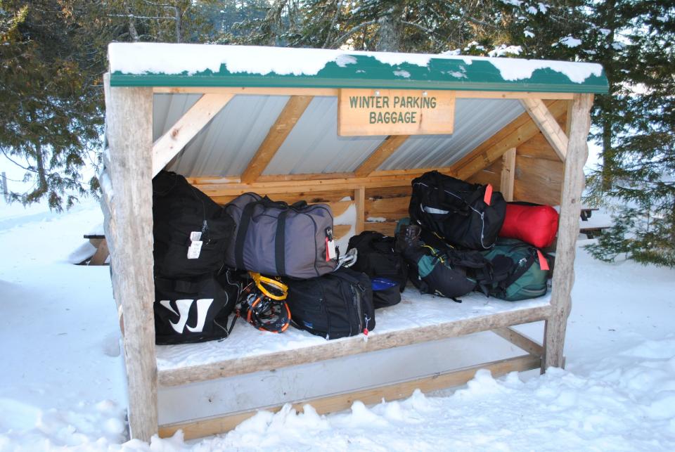 This December 2012 photo shows a small shed where luggage is left for pickup by guests at the Appalachian Mountain Club’s Gorman Chairback Lodge, a backcountry wilderness lodge near Greenville, Maine. In winter, visitors can reach the lodges and cabins only by cross-country skiing in but AMC staff will transport one piece of luggage per guest by snowmobile from town to the lodge. (AP Photo/Lynn Dombek)