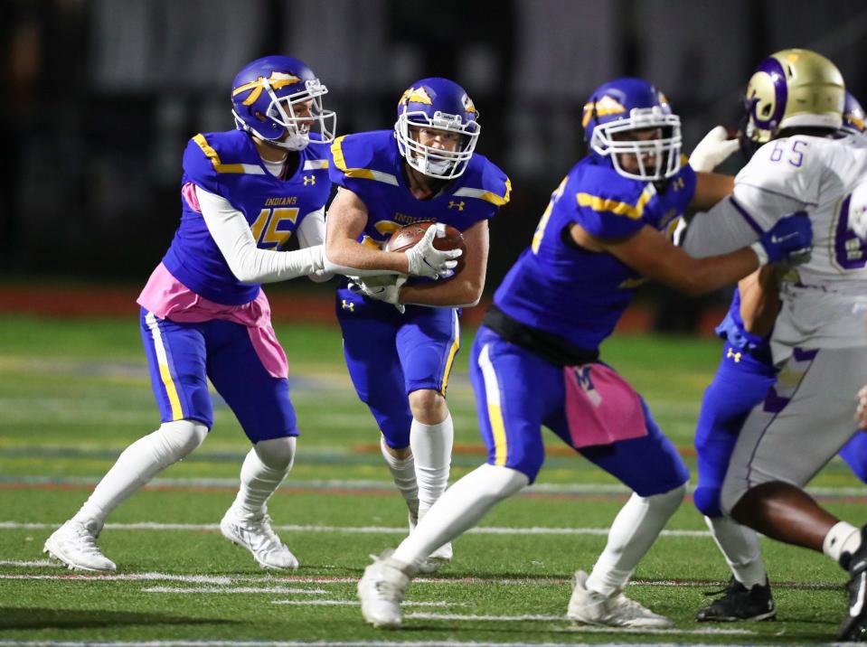 Mahopac's Anthony DeMatteo (15) hands off to Joey Koch (22) during their 34-7 win over Clarkstown North  in the Section 1 Class A quarterfinal football game at Mahopac High School on Friday, October 29, 2021.