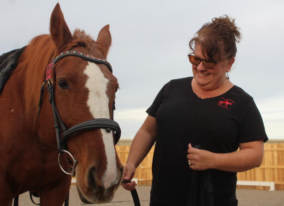 Gina Fiedler and her equestrian vaulting horse Oakley. Fielder hosts the state's only equestrian vaulting club at her home west of Vaughn.