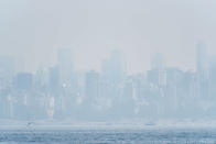 <p>This photo shows the Vancouver skyline under heavy haze as seen from Jericho Beach on August 21, 2018. Thick smoke blanketed Vancouver on Aug. 21, triggering warnings about dangerous particulate matter in the air and comparisons with cities in China and India ranked by the WTO as the worst polluted. It blew in from hundreds of wildfires burning across Canada’s westernmost province of British Columbia as well as U.S. to the south. (Photo from Don MacKinnon/ AFP/Getty Images) </p>