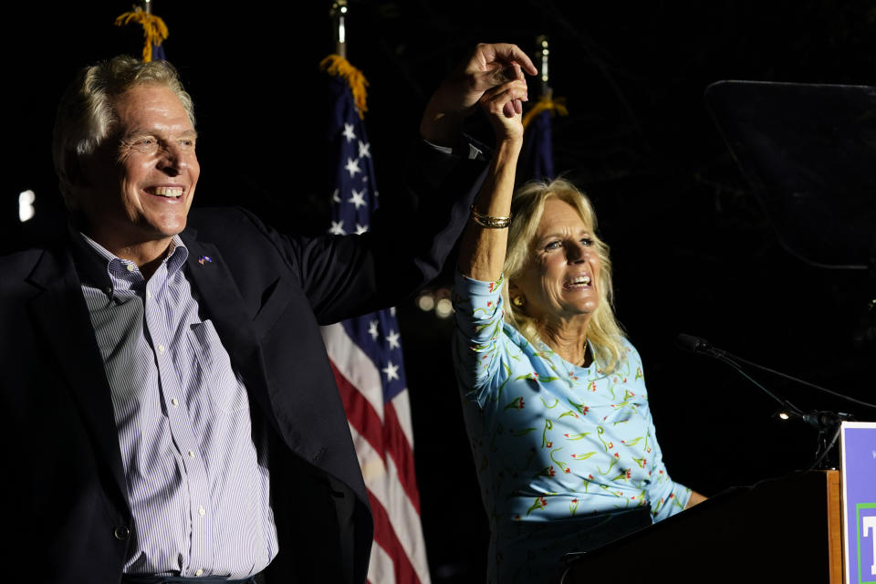 First lady Jill Biden, right, laughs with Democratic gubernatorial candidate Terry McAuliffe, left, during a rally in Richmond, Va., Friday, Oct. 15, 2021. McAuliffe will face Republican Glenn Youngkin in the November election. (AP Photo/Steve Helber)