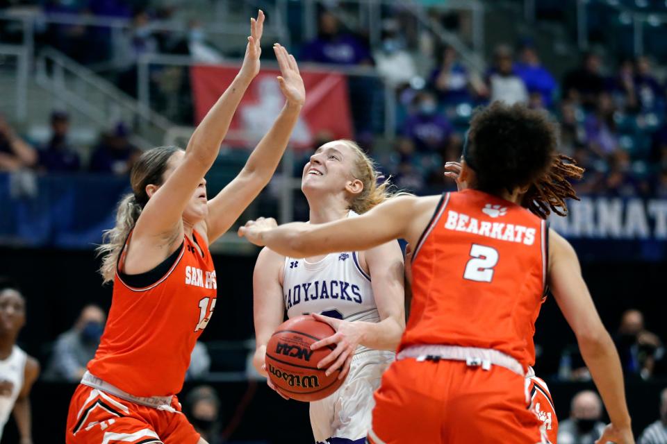 Stephen F. Austin guard Stephanie Visscher, middle, puts up a shot between Sam Houston State forward Kaylee Jefferson (13) and forward Amber Leggett (2) during the first half of an NCAA college basketball game for the Southland Conference women's tournament championship Sunday, March 14, 2021, in Katy, Texas. (AP Photo/Michael Wyke)