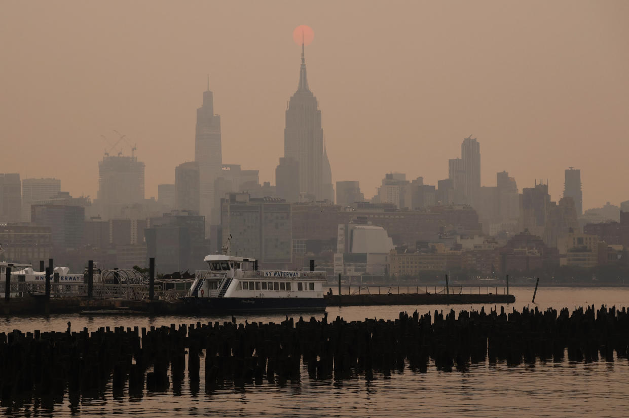 The New York City skyline amid a hazy sky.