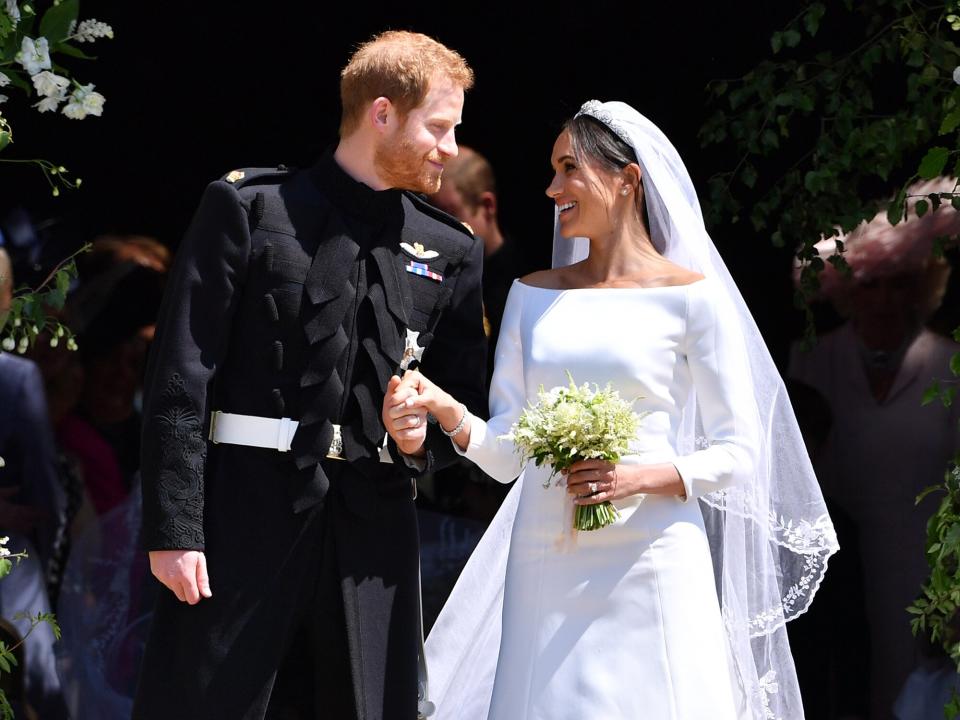 Prince Harry, Duke of Sussex and his wife Meghan, Duchess of Sussex leave from the West Door of St George's Chapel, Windsor Castle, in Windsor on May 19, 2018 in Windsor, England