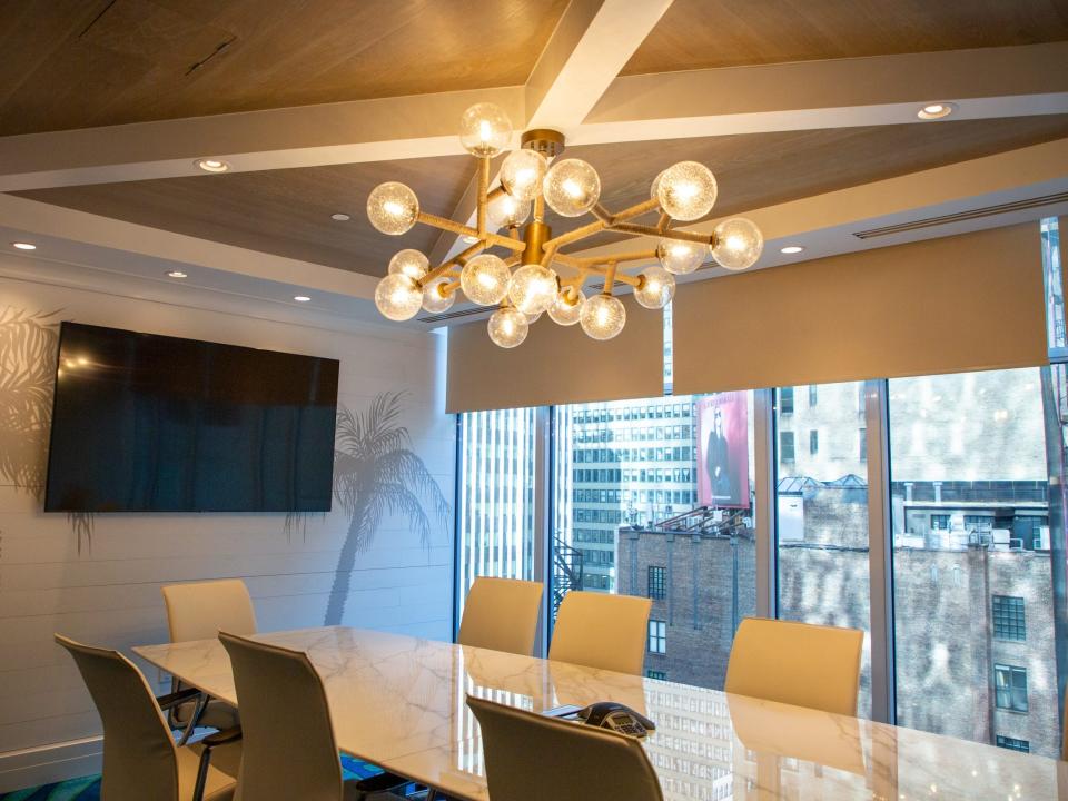 a conference room with a chandelier and TV inside the hotel