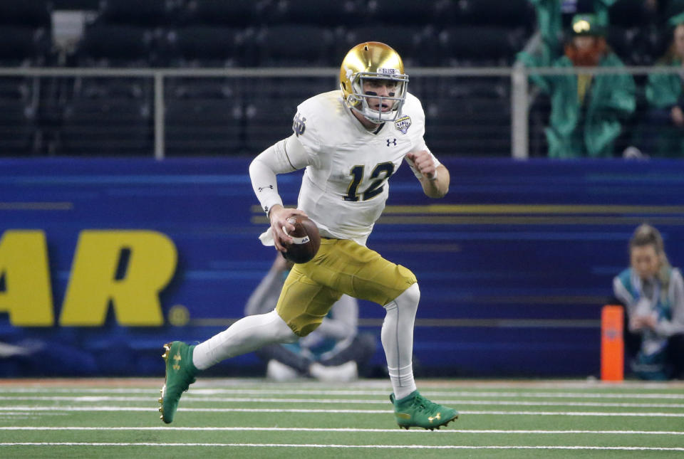 FILE - In this Dec. 29, 2018, file photo, Notre Dame quarterback Ian Book (12) runs the ball against Clemson during the NCAA Cotton Bowl semifinal playoff football game, in Arlington, Texas. Upon his return to campus last winter, Book immediately worked on his leadership skills and also making the difficult and tight downfield passes. Book was rewarded when he was named one of the team’s seven captains. (AP Photo/Michael Ainsworth, File)