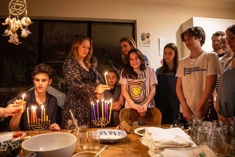 <p>Alicia Silverstone/Instagram</p> Alicia Silverstone lights the menorah with Bear