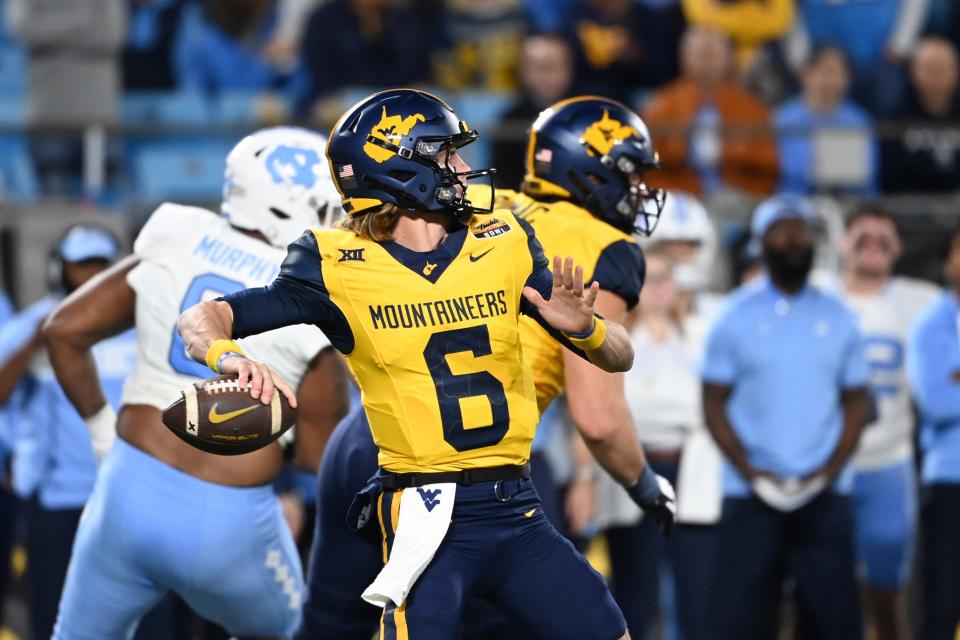 West Virginia Mountaineers quarterback Garrett Greene (6) throws a touchdown pass on the first play of the game in the first half at Bank of America Stadium on Dec. 27, 2023, in Charlotte, NC.