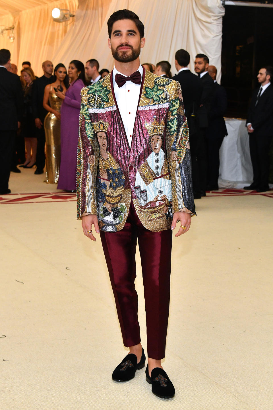 <p>For the Met Gala, Darren Criss donned a seriously embellished jacket with co-ordinating burgundy trousers. The ‘Glee’ star accessorised his D&G aesthetic with a pair of velvet loafers. <em>[Photo: Getty]</em> </p>