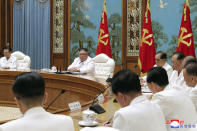 In this photo provided by the North Korean government, North Korean leader Kim Jong Un, second left in the background, attends an emergency Politburo meeting in Pyongyang, North Korea Saturday, July 25, 2020. Independent journalists were not given access to cover the event depicted in this image distributed by the North Korean government. The content of this image is as provided and cannot be independently verified. Korean language watermark on image as provided by source reads: "KCNA" which is the abbreviation for Korean Central News Agency. (Korean Central News Agency/Korea News Service via AP)