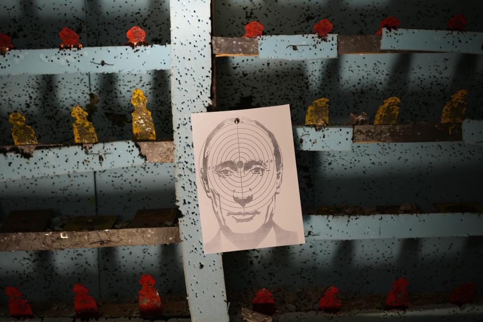 A picture of Russian President Vladimir Putin hangs at a target practice range in Lviv, western Ukraine, Thursday, March 17, 2022. Russia's invasion of Ukraine entered its fourth week on Thursday, with Russian forces largely bogged down outside major cities and shelling them from a distance, raining havoc on civilians. (AP Photo/Bernat Armangue)