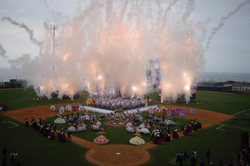 Dancers performs during the Alba Games' opening ceremony at the baseball stadium in La Guaira, Venezuela, Friday, April 21, 2023. (AP Photo/Ariana Cubillos)