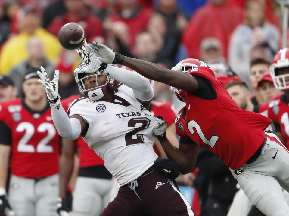 Texas A&M wide receiver Jhamon Ausbon (2) makes a catch as Georgia defensive back Richard LeCounte (2) defends in the first half of an NCAA college football game Saturday, Nov. 23, 2019, in Athens, Ga. (AP Photo/John Bazemore)