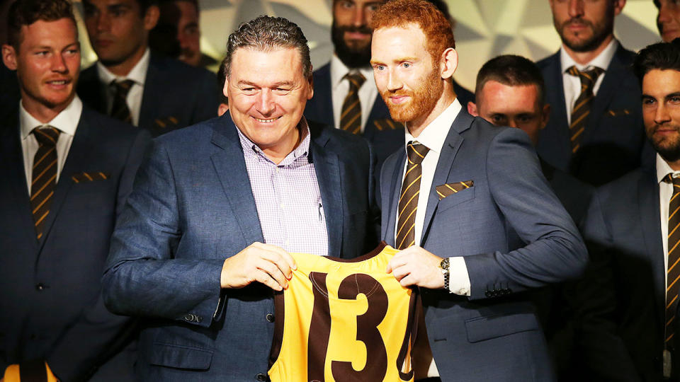 Pictured left, Paul Dear presents Conor Glass with his AFL jumper during Hawthorn's season launch in 2019.