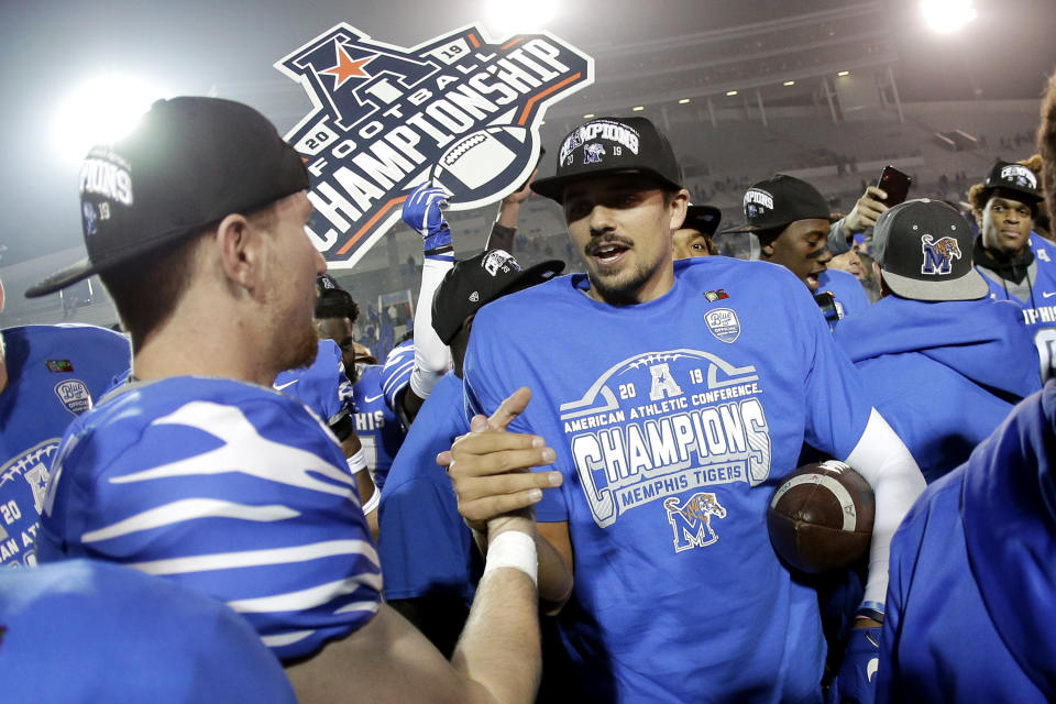 Memphis quarterback Brady White, center, celebrates after his team defeated Cincinnati in an NCAA college football game for the American Athletic Conference championship Saturday, Dec. 7, 2019, in Memphis, Tenn. (AP Photo/Mark Humphrey)