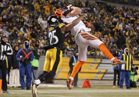 Dec 15, 2013; Pittsburgh, PA, USA; Cincinnati Bengals tight end Tyler Eifert (right) catches a touchdown pass against Pittsburgh Steelers free safety Ryan Clark (25) during the fourth quarter at Heinz Field. The Steelers won 30-20. Mandatory Credit: Charles LeClaire-USA TODAY Sports