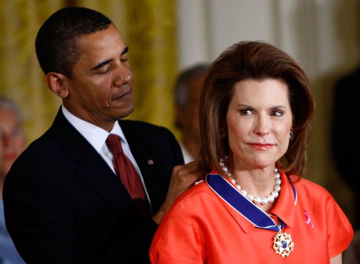 President Obama placing the medal around a woman's neck