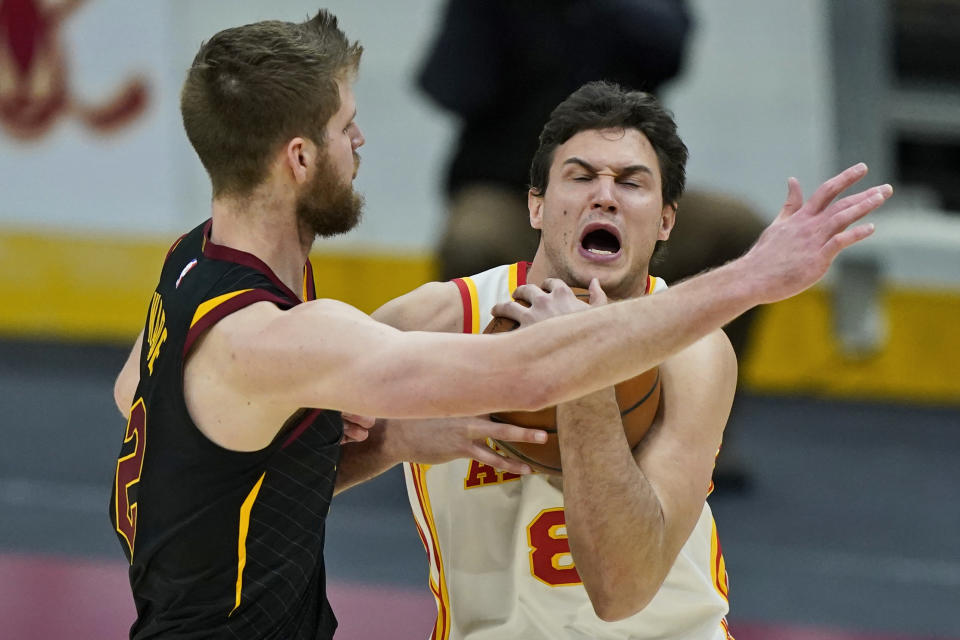 Atlanta Hawks' Danilo Gallinari, right, drives against Cleveland Cavaliers' Dean Wade in the second half of an NBA basketball game, Tuesday, Feb. 23, 2021, in Cleveland. (AP Photo/Tony Dejak)