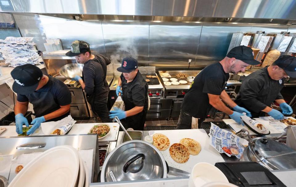 Staff prepares food for guests during the grand opening of Nick the Greek restaurant in Riverbank, Calif., Tuesday, September 12, 2023. Andy Alfaro/aalfaro@modbee.com