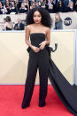 <p>Shahidi looked more grown than <em>Grown-ish</em> in a black jumpsuit with a bow train. (Photo: Getty Images) </p>