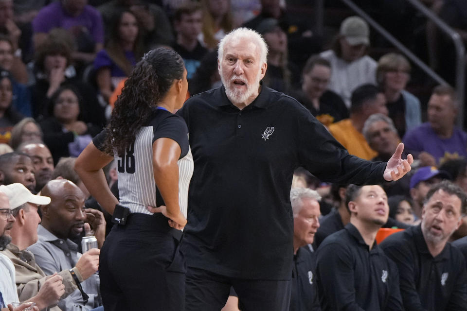 San Antonio Spurs coach Gregg Popovich talks to official Sha'Rae Mitchell during the second half of the team's NBA basketball game against the Phoenix Suns, Thursday, Nov 2, 2023, in Phoenix. (AP Photo/Rick Scuteri)