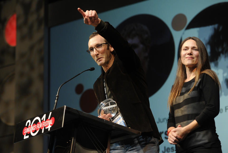 Jesse Moss, director of "The Overnighters," accepts the U.S. Documentary Special Jury Award for Intuitive Filmmaking alongside his wife Amanda, a producer on the film, during the 2014 Sundance Film Festival Awards Ceremony on Saturday, Jan. 25, 2014, in Park City, Utah. (Photo by Chris Pizzello/Invision/AP)