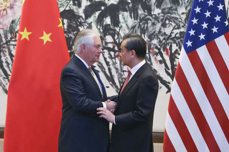 Chinese Foreign Minister Wang Yi (R) shakes hands with U.S. Secretary of State Rex Tillerson after a joint press conference at Diaoyutai State Guesthouse in Beijing, China, March 18. REUTERS/Lintao Zhang