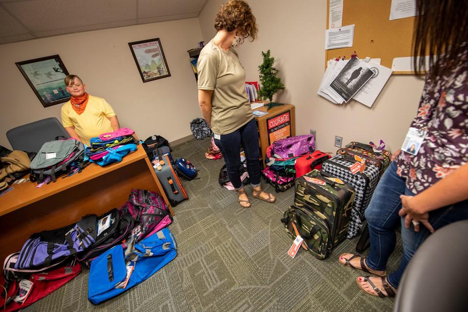 Curvin Coxen, left, smiles after his bags fill up an office at York County Office of Children, Youth & Families.