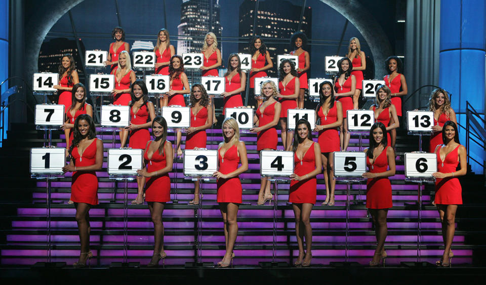 Deal or No Deal models in red dresses holding briefcases